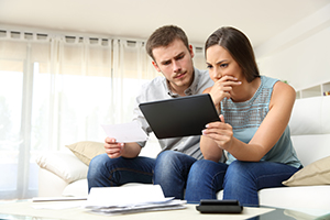 young couple looking at visa bill